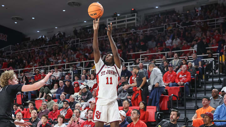 Nov 15, 2025; Queens, New York, USA;  St. John's basketball guard Ian Jackson (11) takes a three-point shot past William & Mary Tribe guard Reese Miller (0) in the second half at Carnesecca Arena. 
