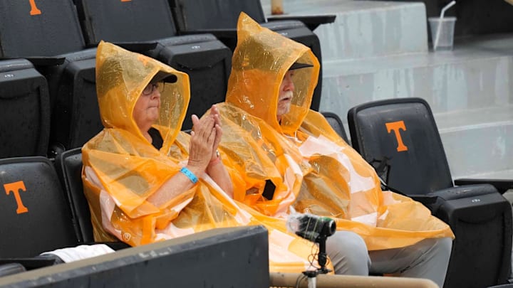Tennessee fans try to stay dry after a weather delay during a NCAA baseball game between the Tennessee Volunteers and Vanderbilt Commodores at Lindsey Nelson Stadium on May 11, 2025. Vanderbilt won 7-5 against Tennessee.