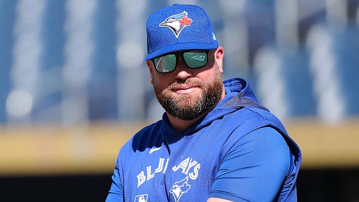 Jul 21, 2025; Toronto, Ontario, CAN; Toronto Blue Jays manager John Schneider (14) walks onto the field during practice before a game against the New York Yankees at Rogers Centre