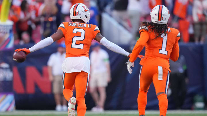 Oct 8, 2023; Denver, Colorado, USA; Denver Broncos cornerback Pat Surtain II (2) celebrates his interception with cornerback Tremon Smith (1) in the second half against the New York Jets at Empower Field at Mile High. Mandatory Credit: Ron Chenoy-USA TODAY Sports