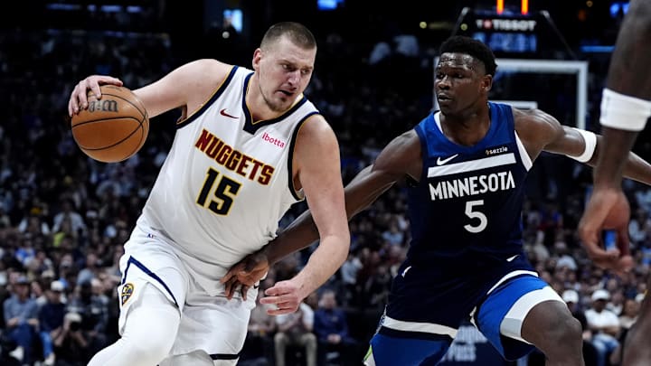 Mar 12, 2025; Denver, Colorado, USA; Minnesota Timberwolves guard Anthony Edwards (5) defends Denver Nuggets center Nikola Jokic (15) in the second half at Ball Arena. 