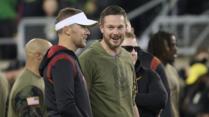 Nov 11, 2023; Eugene, Oregon, USA; USC Trojans head coach Lincoln Riley, left, and Oregon Ducks head coach Dan Lanning talk before a game at Autzen Stadium. Mandatory Credit: Troy Wayrynen-Imagn Images