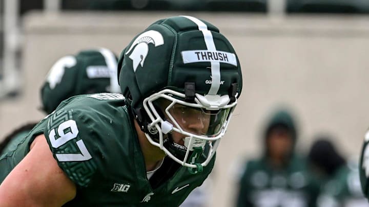 Michigan State's Cal Thrush, center, lines up before a play during the football Spring Showcase on Saturday, April 18, 2026, at Spartan Stadium in East Lansing.