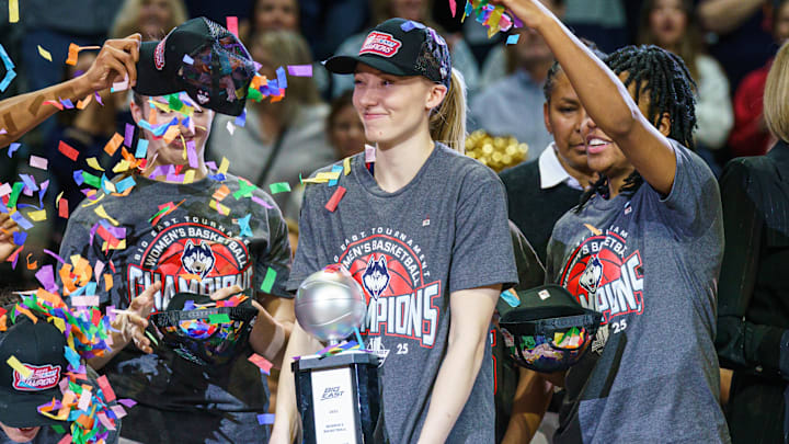Mar 10, 2025; Uncasville, CT, USA; UConn Huskies guard Paige Bueckers (5) holds her “Most Outstanding Player” trophy as the team celebrates their Big East Championship win over the Creighton Bluejays at Mohegan Sun Arena. Mandatory Credit: David Butler II-Imagn Images Mar 10, 2025; Uncasville, CT, USA; UConn Huskies guard Paige Bueckers (5) holds her “Most Outstanding Player” trophy as the team celebrates their Big East Championship win over the Creighton Bluejays at Mohegan Sun Arena. Mandatory Credit: David Butler II-Imagn Images
