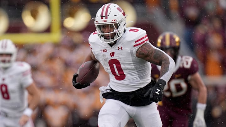Nov 25, 2023; Minneapolis, Minnesota, USA; Wisconsin Badgers running back Braelon Allen (0) runs for a first down against the Minnesota Golden Gophers during the second quarter at Huntington Bank Stadium. 