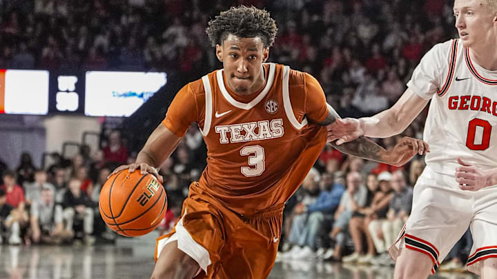 Feb 21, 2026; Athens, Georgia, USA; Texas Longhorns forward Dailyn Swain (3) dribbles against Georgia Bulldogs guard Blue Cain (0) at Stegeman Coliseum. Mandatory Credit: Dale Zanine-Imagn Images