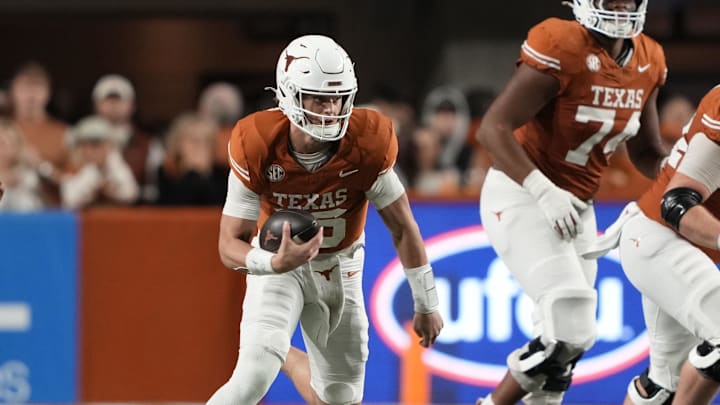 Texas Longhorns quarterback Arch Manning keeps the ball for yardage during the first half against the Texas A&M Aggies at Darrell K Royal-Texas Memorial Stadium.