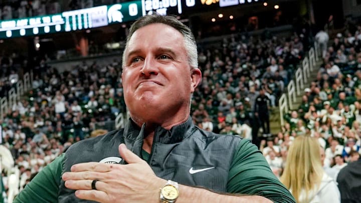 Michigan State's new football coach Pat Fitzgerald pats his heart at the crowd in attendance for the Spartans basketball game against Iowa on Tuesday, Dec. 2, 2025, at the Breslin Center in East Lansing. Michigan State's new football coach Pat Fitzgerald pats his heart at the crowd in attendance for the Spartans basketball game against Iowa on Tuesday, Dec. 2, 2025, at the Breslin Center in East Lansing.