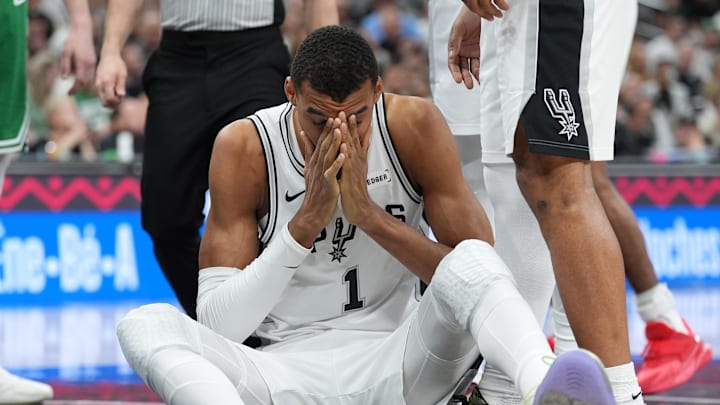 Mar 10, 2026; San Antonio, Texas, USA; San Antonio Spurs forward Victor Wembanyama (1) sits on the court after getting fouled against the Boston Celtics during the first half at Frost Bank Center. Mandatory Credit: Daniel Dunn-Imagn Images