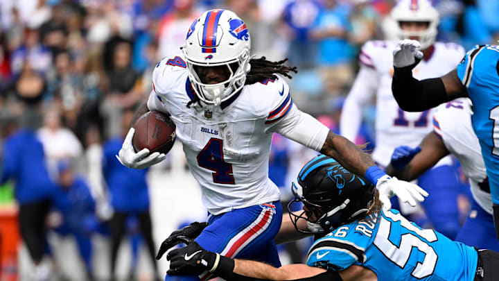 Buffalo Bills running back James Cook III runs against Carolina Panthers linebacker Christian Rozeboom. Buffalo Bills running back James Cook III runs against Carolina Panthers linebacker Christian Rozeboom.