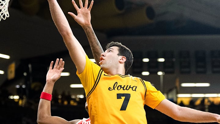 Iowa forward Alvaro Folgueiras (7) drives to the basket against Ohio State forward Amare Bynum (1) Feb. 25, 2026 at Carver-Hawkeye Arena in Iowa City, Iowa.