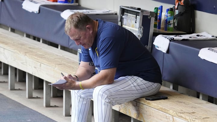 Jun 29, 2025; Milwaukee, Wisconsin, USA; Milwaukee Brewers manager Pat Murphy (49) works on his line card before their game against the Colorado Rockies at American Family Field. Mandatory Credit: Michael McLoone-Imagn Images