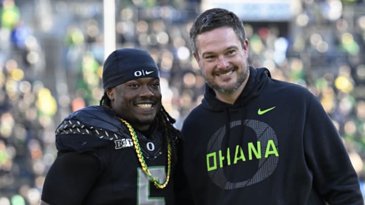 Nov 22, 2025; Eugene, Oregon, USA; Oregon Ducks running back Noah Whittington (6) poses for a photo with head coach Dan Lanning before the game against the Southern California Trojans at Autzen Stadium. 