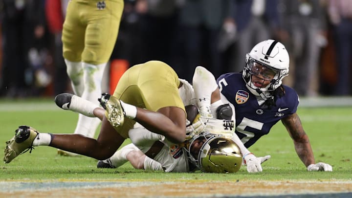 Jan 9, 2025; Miami, FL, USA; Notre Dame Fighting Irish cornerback Christian Gray (29) intercepts the ball in front of Penn State Nittany Lions wide receiver Omari Evans (5) in the second half in the Orange Bowl at Hard Rock Stadium. 