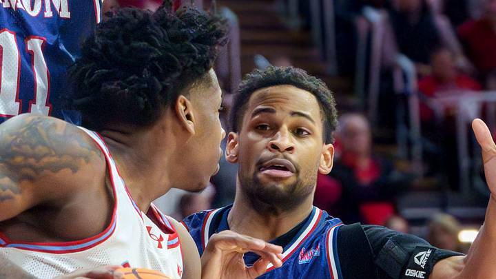 Belmont's Drew Scharnowski (11) and Isaiah West (3) guard Bradley's Jaquan Johnson in the first half of their college basketball game Monday, Feb. 9, 2026 at Carver Arena in Peoria. The Braves defeated the Bruins 95-84.