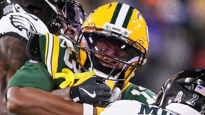 Green Bay Packers wide receiver Dontayvion Wicks (13) is tackled by a couple Eagles defenders during their November game.