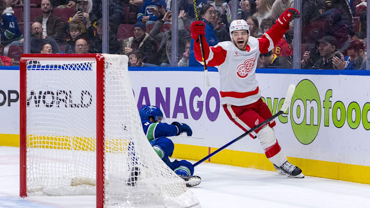 Feb 2, 2025; Vancouver, British Columbia, CAN; Vancouver Canucks forward Conor Garland (8) watches as Detroit Red Wings forward Alex DeBrincat (93) celebrates his overtime goal at Rogers Arena. Mandatory Credit: Bob Frid-Imagn Images