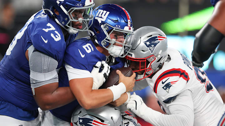 Aug 21, 2025; East Rutherford, New Jersey, USA; New York Giants quarterback Jaxson Dart (6) is tackled by New England Patriot Aug 21, 2025; East Rutherford, New Jersey, USA; New York Giants quarterback Jaxson Dart (6) is tackled by New England Patriot