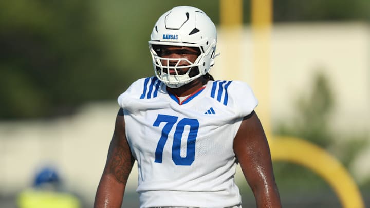 Kansas redshirt senior offensive lineman Kobe Baynes (70) walks towards positions during practice at the Murfin Family Practice Fields on Aug. 8, 2025.