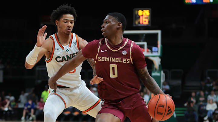Jan 8, 2025; Coral Gables, Florida, USA; Florida State Seminoles guard Chandler Jackson (0) drives to the basket past Miami Hurricanes guard Jalil Bethea (3) during the first half at Watsco Center. Mandatory Credit: Sam Navarro-Imagn Images
