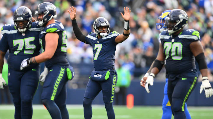 Nov 3, 2024; Seattle, Washington, USA; Seattle Seahawks quarterback Geno Smith (7) celebrates after throwing a touchdown pass against the Los Angeles Rams during the first half at Lumen Field.