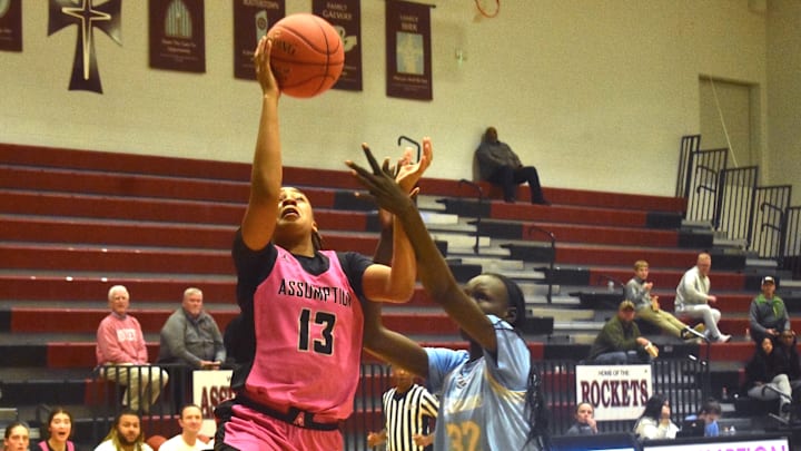 Assumption senior Ashlinn James goes up for a shot against Danville Christian center Achan Deng in a game Jan.  13, 2026. 
