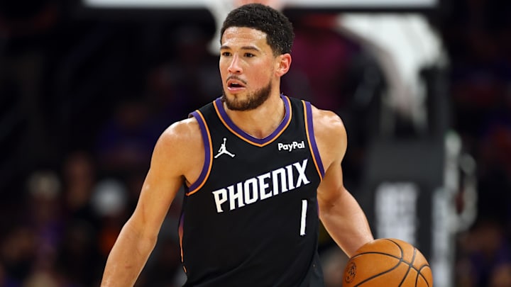 Apr 17, 2026; Phoenix, Arizona, USA; Phoenix Suns guard Devin Booker (1) against the Golden State Warriors during the play-in rounds of the 2026 NBA Playoffs at Mortgage Matchup Center. Mandatory Credit: Mark J. Rebilas-Imagn Images