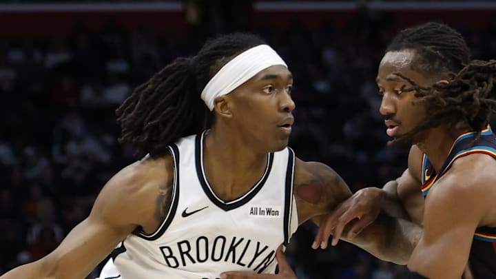 Mar 7, 2026; Detroit, Michigan, USA;  Brooklyn Nets guard Terance Mann (14) dribbles defended by Detroit Pistons guard Daniss Jenkins (24) in the first half at Little Caesars Arena. Mandatory Credit: Rick Osentoski-Imagn Images