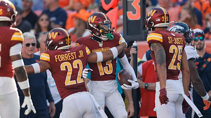 Sep 17, 2023; Denver, Colorado, USA; Washington Commanders cornerback Emmanuel Forbes Jr. (13) celebrates his interception with safety Darrick Forrest (22) and cornerback Benjamin St-Juste (25) and safety Percy Butler (35) in the third quarter against the Denver Broncos at Empower Field at Mile High. Mandatory Credit: Isaiah J. Downing-Imagn Images