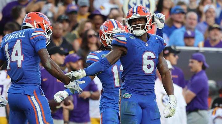 Nov 16, 2024; Gainesville, Florida, USA; Florida Gators linebacker Shemar James (6) and defensive back Jordan Castell (14) high five against the LSU Tigers during the first half at Ben Hill Griffin Stadium. Mandatory Credit: Kim Klement Neitzel-Imagn Images