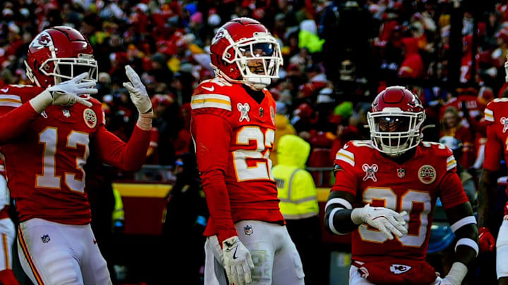 Dec 21, 2024; Kansas City, Missouri, USA; Kansas City Chiefs cornerback Trent McDuffie (22) celebrates with teammates after an interception during the first half against the Houston Texans at GEHA Field at Arrowhead Stadium. Mandatory Credit: Jay Biggerstaff-Imagn Images