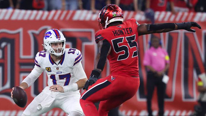 Nov 20, 2025; Houston, Texas, USA; Buffalo Bills quarterback Josh Allen (17) runs with the ball as Houston Texans defensive end Danielle Hunter (55) applies defensive pressure during the second half at NRG Stadium. Mandatory Credit: Troy Taormina-Imagn Images