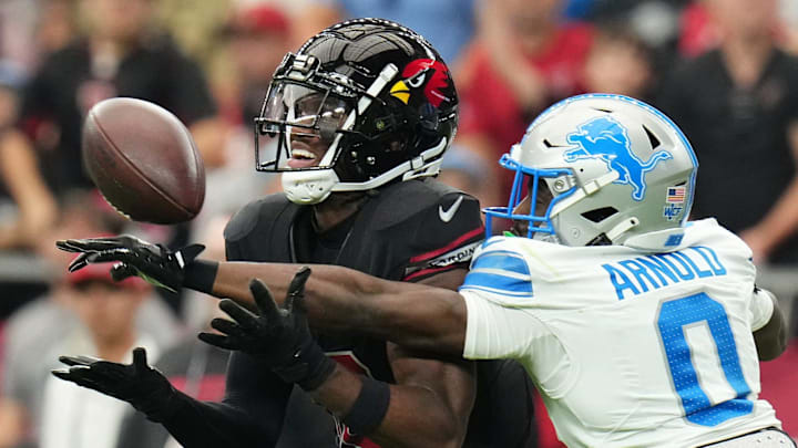 Arizona Cardinals receiver Marvin Harrison Jr. (18) tries to catch the ball as Detroit Lions cornerback Terrion Arnold (0) 