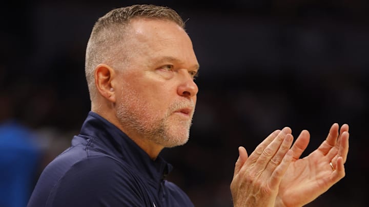 Oct 17, 2024; Minneapolis, Minnesota, USA; Denver Nuggets head coach Michael Malone claps as his team plays the Minnesota Timberwolves in the first quarter at Target Center. Mandatory Credit: Bruce Kluckhohn-Imagn Images