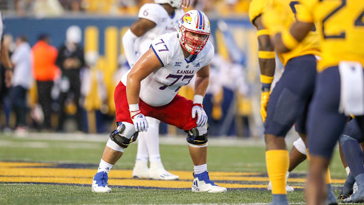 Sep 10, 2022; Morgantown, West Virginia, USA; Kansas Jayhawks offensive lineman Bryce Cabeldue (77) pauses before a snap during the second quarter against the West Virginia Mountaineers at Mountaineer Field at Milan Puskar Stadium. Sep 10, 2022; Morgantown, West Virginia, USA; Kansas Jayhawks offensive lineman Bryce Cabeldue (77) pauses before a snap during the second quarter against the West Virginia Mountaineers at Mountaineer Field at Milan Puskar Stadium.