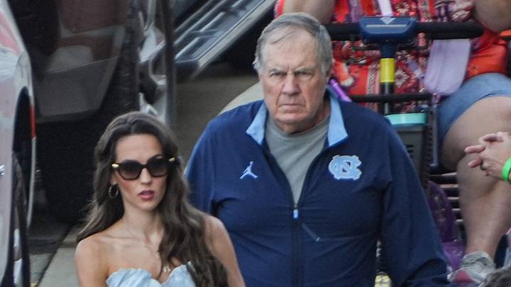 University of North Carolina coach Bill Belichick and Jordon Hudson get off a bus together. University of North Carolina coach Bill Belichick and Jordon Hudson get off a bus together.