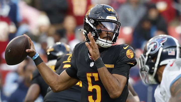 Dec 1, 2024; Landover, Maryland, USA; Washington Commanders quarterback Jayden Daniels (5) passes the ball as Tennessee Titans linebacker Arden Key (49) chases during the third quarter at Northwest Stadium. Mandatory Credit: Geoff Burke-Imagn Images Dec 1, 2024; Landover, Maryland, USA; Washington Commanders quarterback Jayden Daniels (5) passes the ball as Tennessee Titans linebacker Arden Key (49) chases during the third quarter at Northwest Stadium. Mandatory Credit: Geoff Burke-Imagn Images
