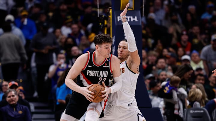 Feb 10, 2025; Denver, Colorado, USA; Portland Trail Blazers center Donovan Clingan (23) controls the ball as Denver Nuggets forward Aaron Gordon (32) guards in the third quarter at Ball Arena. Mandatory Credit: Isaiah J. Downing-Imagn Images