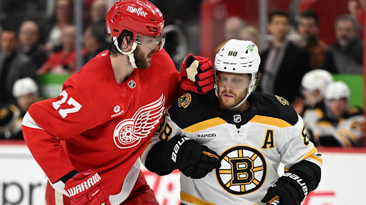 Mar 29, 2025; Detroit, Michigan, USA; Boston Bruins right wing David Pastrnak (88) collides with Detroit Red Wings center in the second period at Little Caesars Arena. Mandatory Credit: Lon Horwedel-Imagn Images