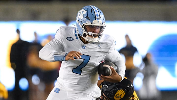 Oct 17, 2025; Berkeley, California, USA; North Carolina Tar Heels quarterback Gio Lopez (7) evades tackle by California Golden Bears linebacker Cade Uluave (0) in the second quarter at California Memorial Stadium. Mandatory Credit: Eakin Howard-Imagn Images Oct 17, 2025; Berkeley, California, USA; North Carolina Tar Heels quarterback Gio Lopez (7) evades tackle by California Golden Bears linebacker Cade Uluave (0) in the second quarter at California Memorial Stadium. Mandatory Credit: Eakin Howard-Imagn Images
