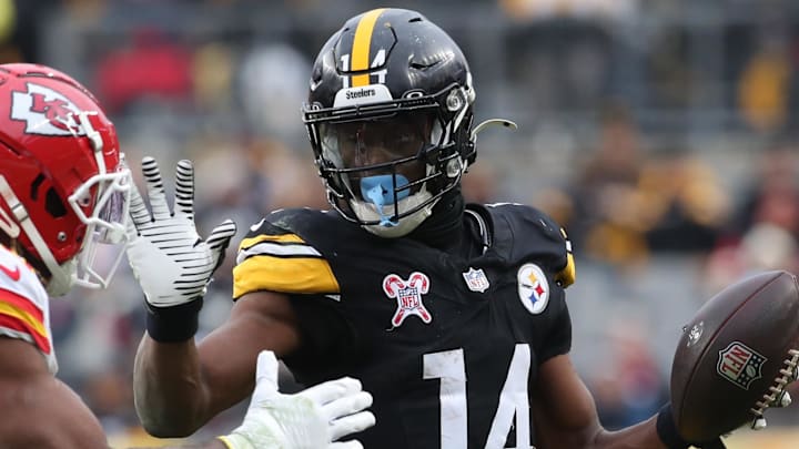 Dec 25, 2024; Pittsburgh, Pennsylvania, USA;  Pittsburgh Steelers wide receiver George Pickens (14) runs after a catch as Kansas City Chiefs safety Justin Reid (20) defends during the fourth quarter  at Acrisure Stadium. Mandatory Credit: Charles LeClaire-Imagn Images