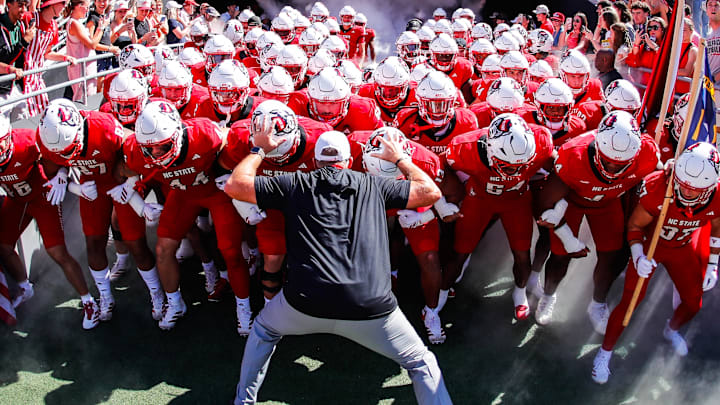 Oct 4, 2025; Raleigh, North Carolina, USA;  NC State Wolfpack head coach Dave Doeren with his team prepare to run out prior to the first half of the game against Campbell Fighting Camels at Carter-Finley Stadium. Mandatory Credit: Jaylynn Nash-Imagn Images