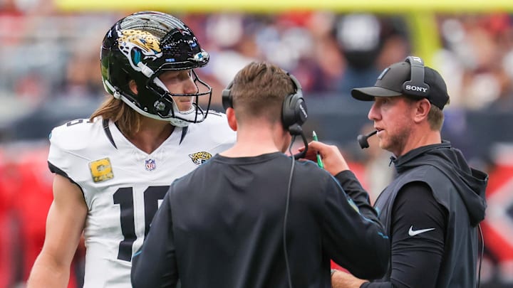 Nov 9, 2025; Houston, Texas, USA; Jacksonville Jaguars quarterback Trevor Lawrence (16) talks with head coach Liam Coen during the first half of a game against the Houston Texans at NRG Stadium. Mandatory Credit: Thomas Shea-Imagn Images