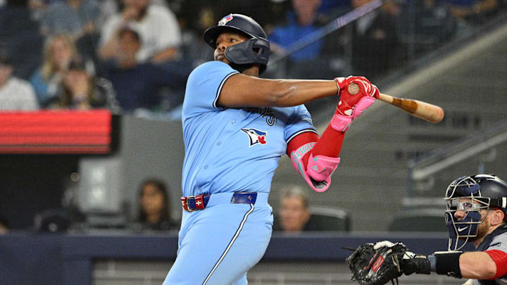 Sep 24, 2024; Toronto, Ontario, CAN; Toronto Blue Jays designated hitter Vladimir Guerrero Jr. (27) hits a two run RBI double against the Boston Red Sox in the third inning at Rogers Centre.