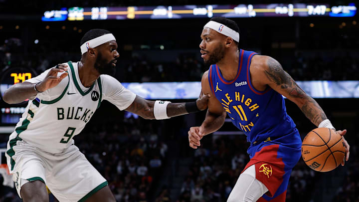 Jan 11, 2026; Denver, Colorado, USA; Denver Nuggets guard Bruce Brown (11) controls the ball as Milwaukee Bucks forward Bobby Portis Jr. (9) guards in the second quarter at Ball Arena. Mandatory Credit: Isaiah J. Downing-Imagn Images