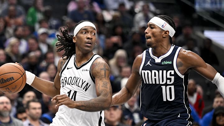 Dec 12, 2025; Dallas, Texas, USA; Brooklyn Nets guard Terance Mann (14) looks to move the ball past Dallas Mavericks guard Brandon Williams (10) during the game between the Mavericks and the Nets at the American Airlines Center. Mandatory Credit: Jerome Miron-Imagn Images