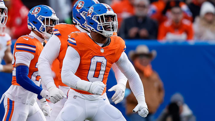 Jan 5, 2025; Denver, Colorado, USA; Denver Broncos linebacker Jonathon Cooper (0) reacts ahead of teammates after a sack in the second quarter against the Kansas City Chiefs at Empower Field at Mile High. 