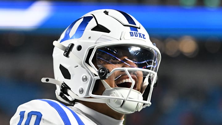 Dec 6, 2025; Charlotte, NC, USA; Duke Blue Devils quarterback Darian Mensah (10) celebrates after the Blue Devils score a touchdown in overtime during the  ACC Championship game at Bank of America Stadium. Mandatory Credit: Bob Donnan-Imagn Images