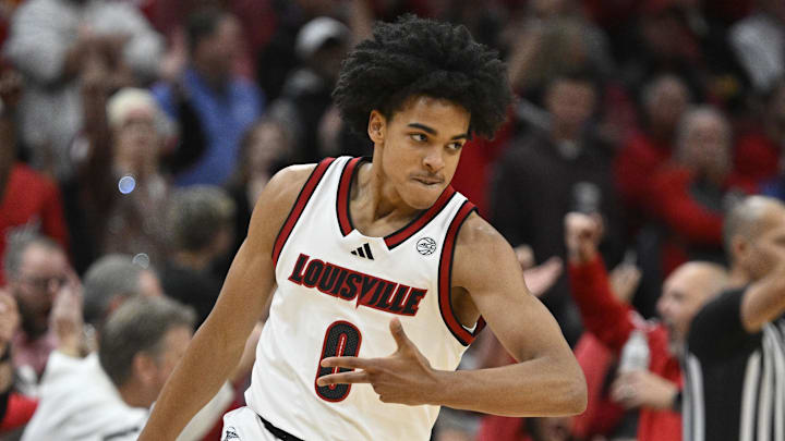 Nov 11, 2025; Louisville, Kentucky, USA;  Louisville Cardinals guard Mikel Brown Jr. (0) reacts after making a three pointer against the Kentucky Wildcats during the first half at KFC Yum! Center. 