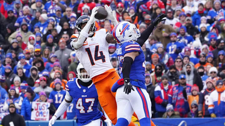 Jan 12, 2025; Orchard Park, New York, USA; Denver Broncos wide receiver Courtland Sutton (14) catches a pass as Buffalo Bills linebacker Terrel Bernard (43) defends during the second quarter in an AFC wild card game at Highmark Stadium. 